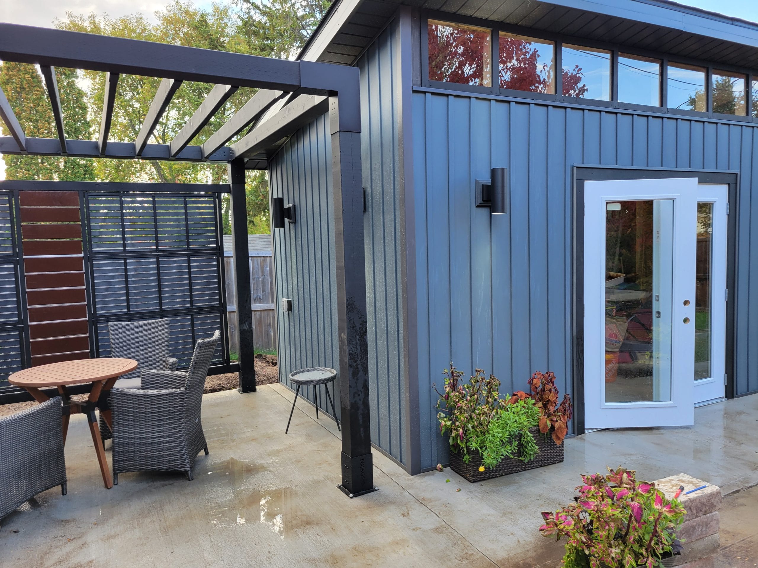 Modern patio with outdoor seating and plants.