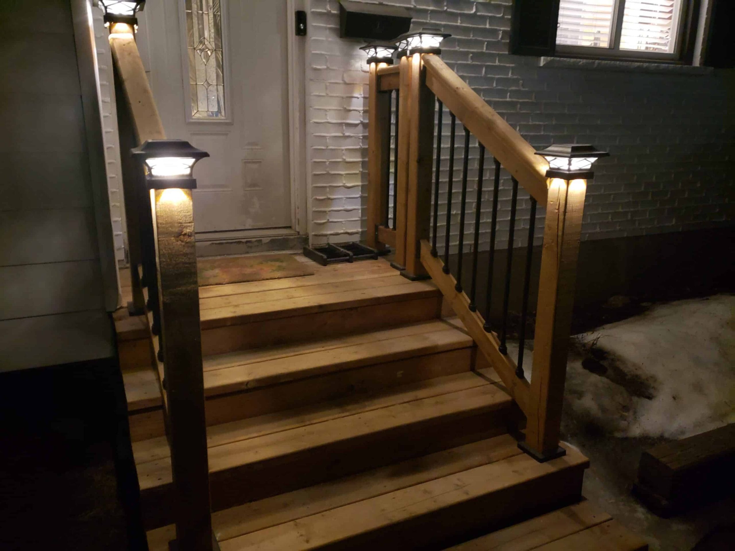 Illuminated wooden porch stairs at night