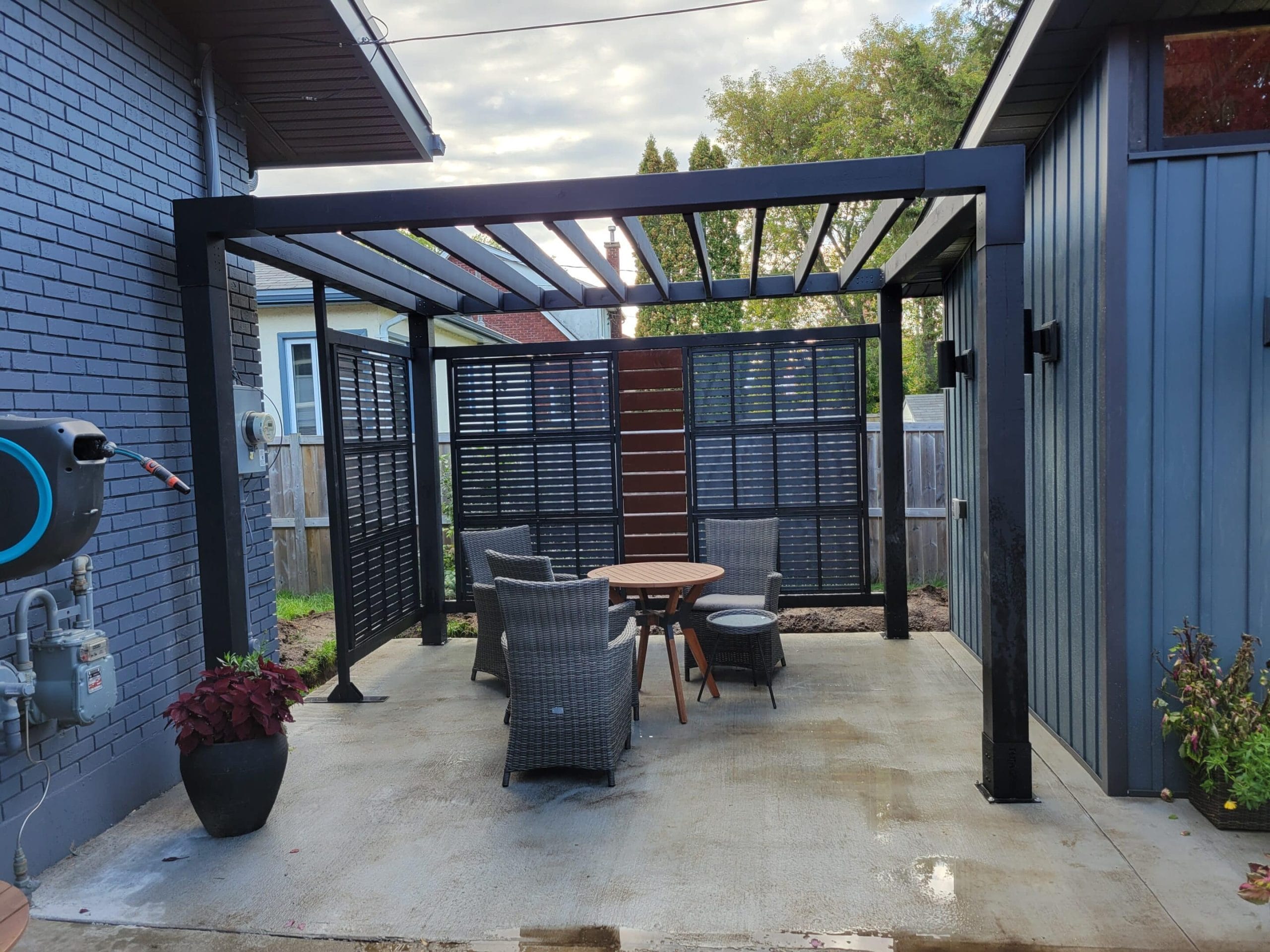 Outdoor patio with pergola and seating area.