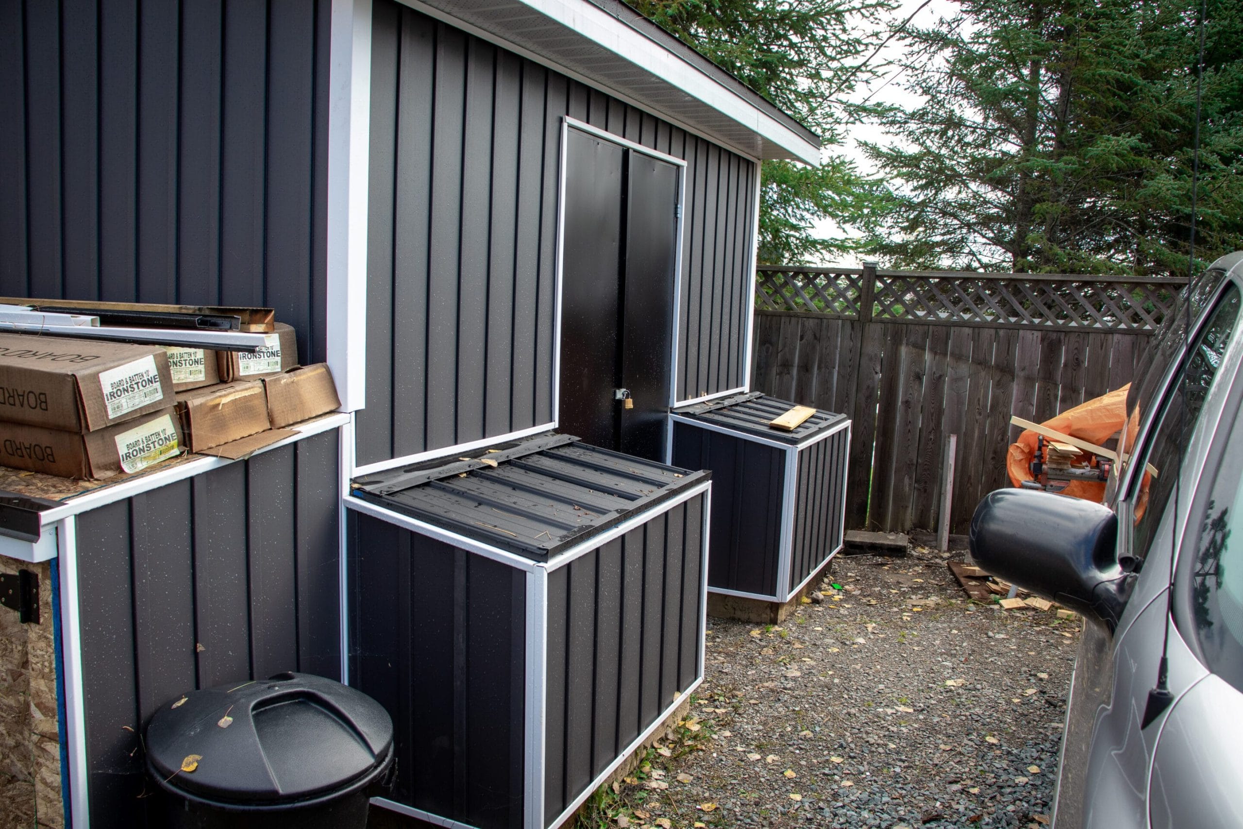 Outdoor storage shed with vinyl siding and "bear" boxes